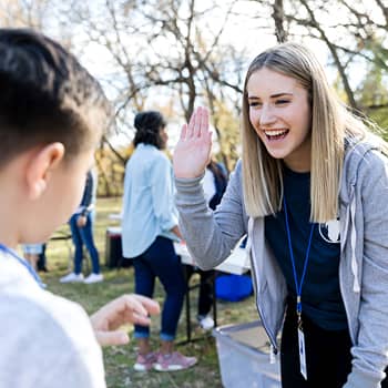 Youth volunteer high fiving