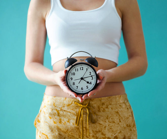 Woman holding clock